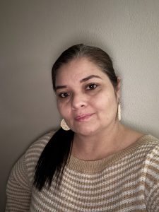 Headshot of Jennifer in front of a wall