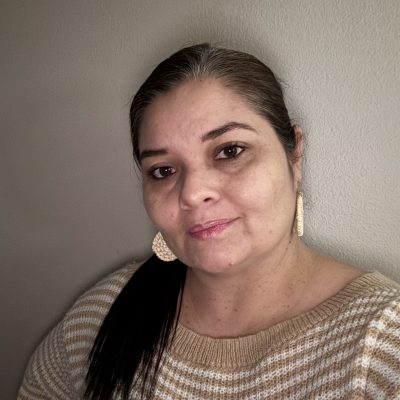 Headshot of Jennifer in front of a wall