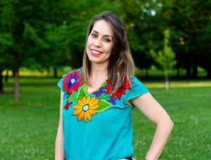 Rosalba standing outside in front of trees