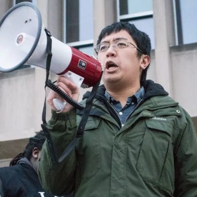 Leland speaking into a megaphone outside